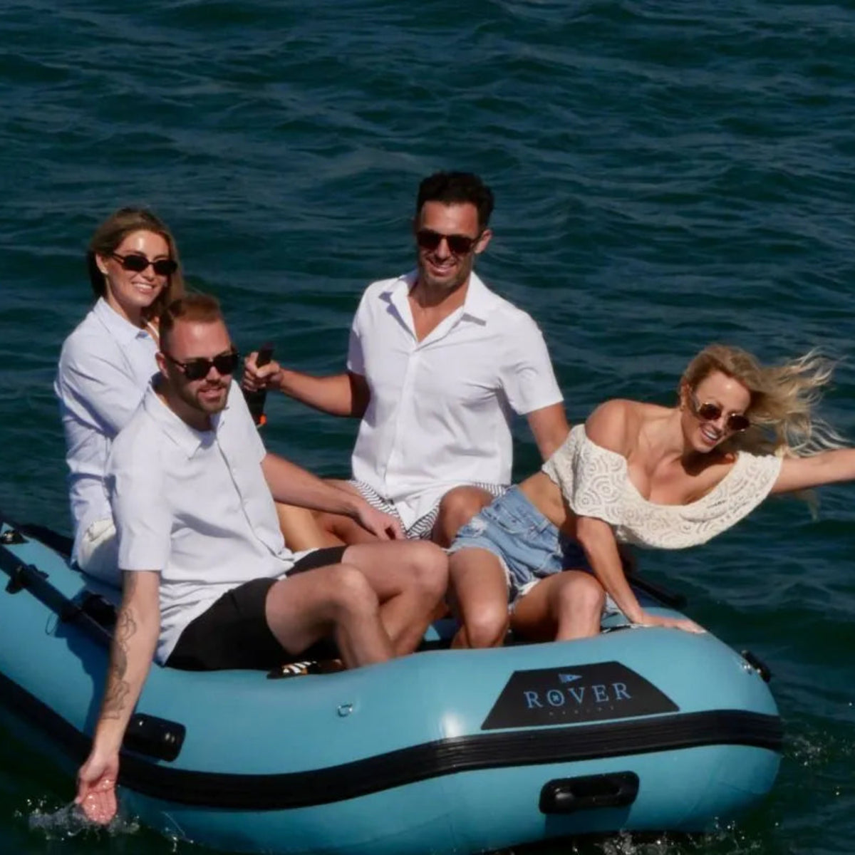A lifestyle group of people riding and having fun together on the 10ft battle boat on water.