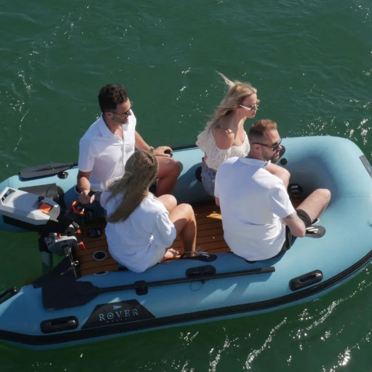 An action shot of a group enjoying a fun ride on the 10ft battle boat outdoors.