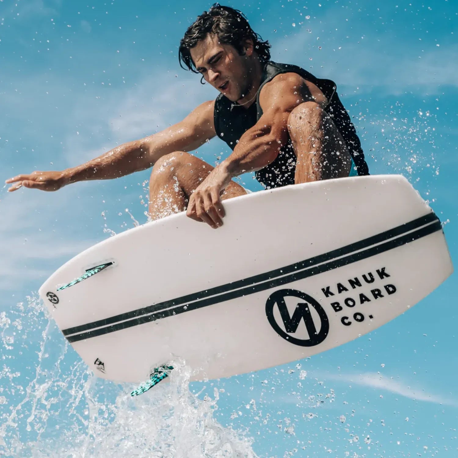 Surfer performing an aerial trick on Burnsy Pro Orange Whip wakesurf board.