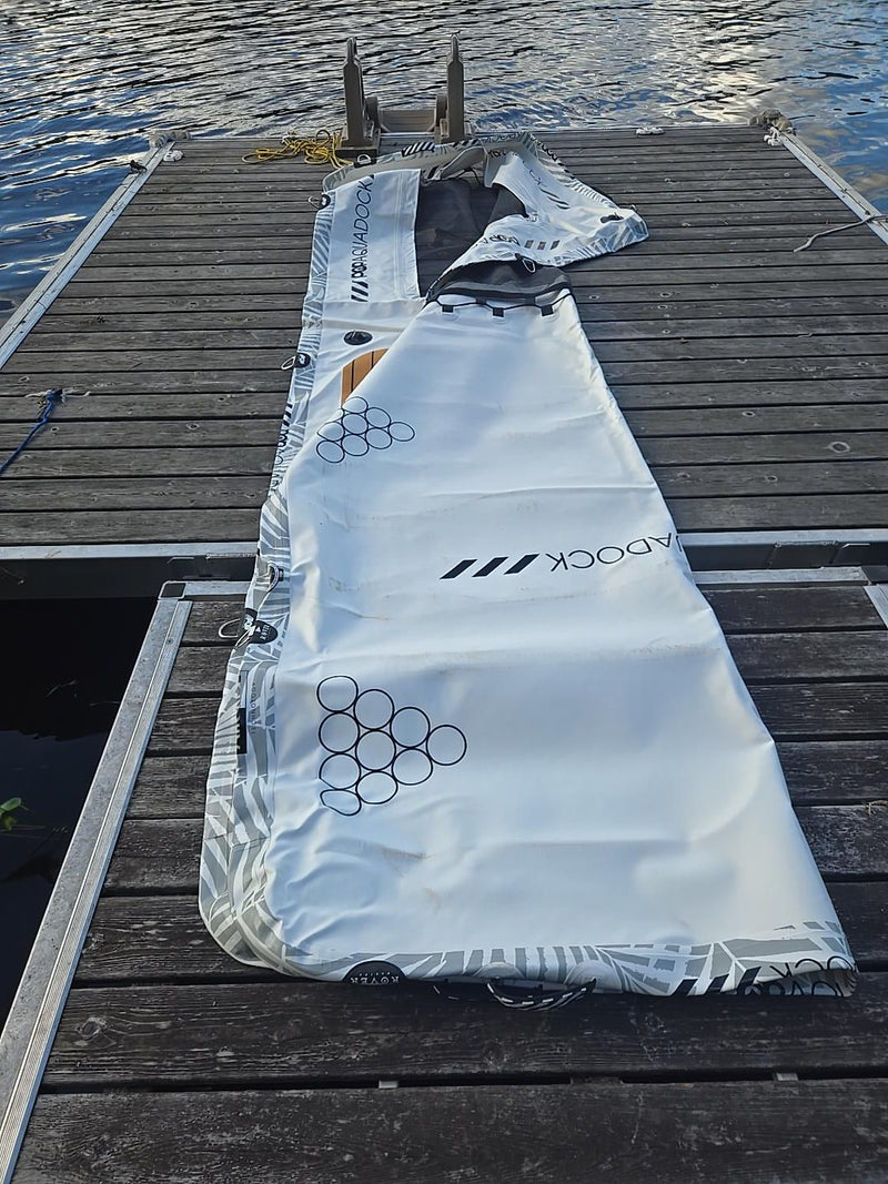 AquaDock unrolled on a wooden dock before inflating