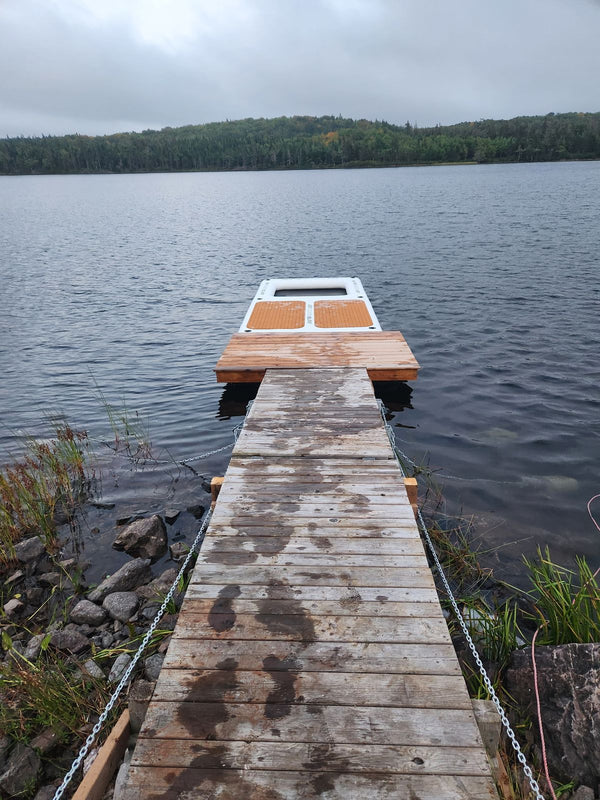 AquaDock tied off the end of a wooden dock on a lake