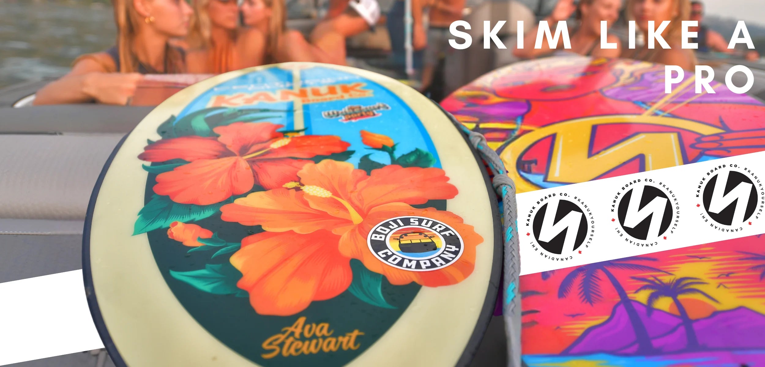 Close-up of Kanuk skimboard with hibiscus floral design, Ava Stewart pro model, on a boat with friends in the background.