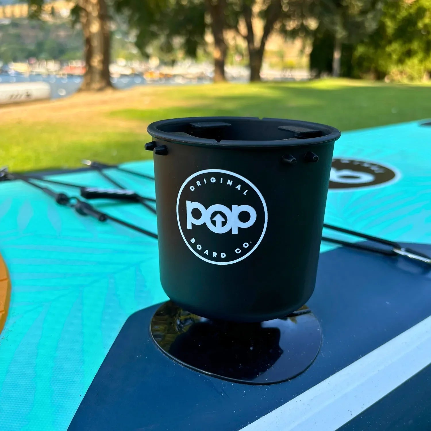 Easy-to-attach POP universal cup holder mounted on paddleboard deck.