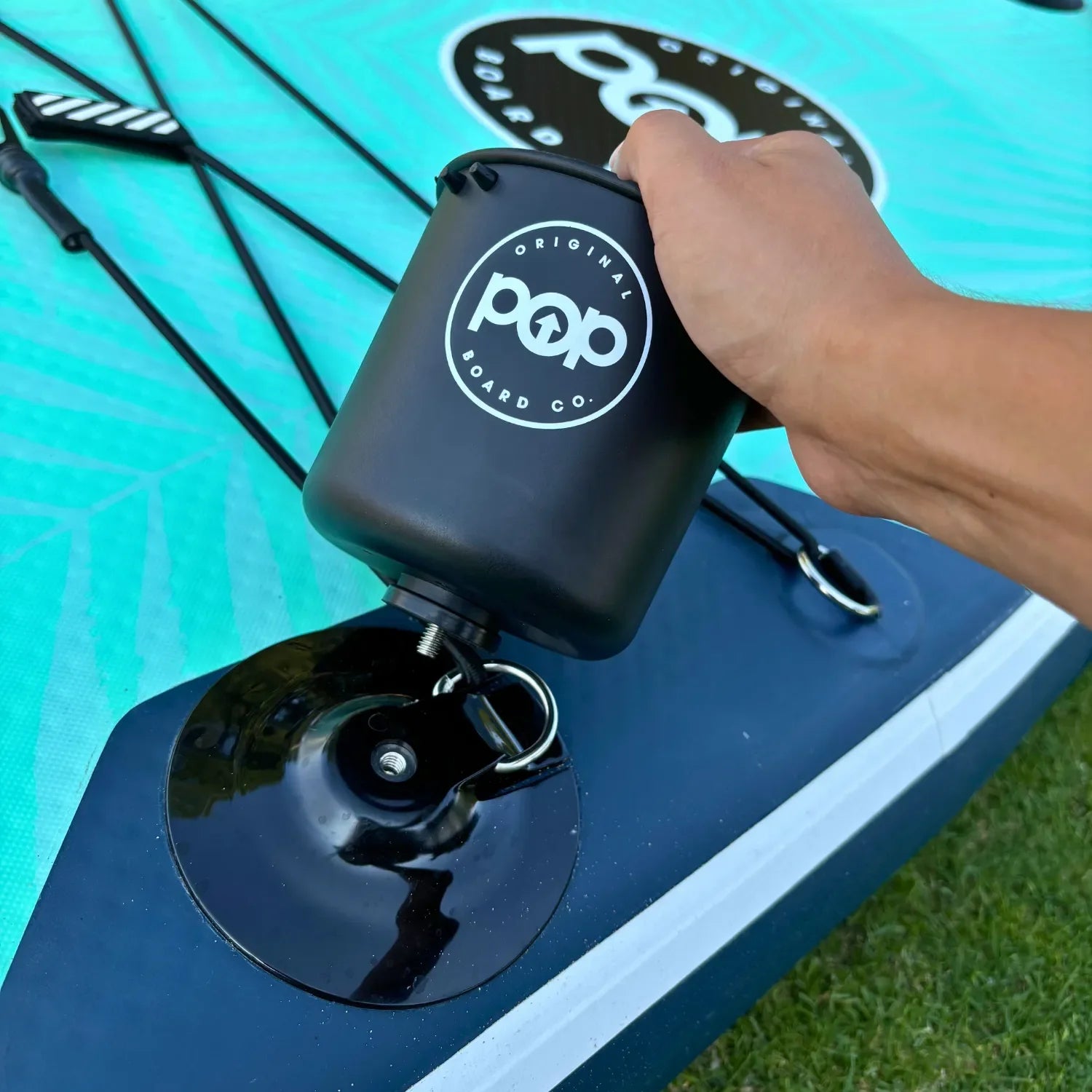 POP paddleboard cup holder being installed securely on SUP.