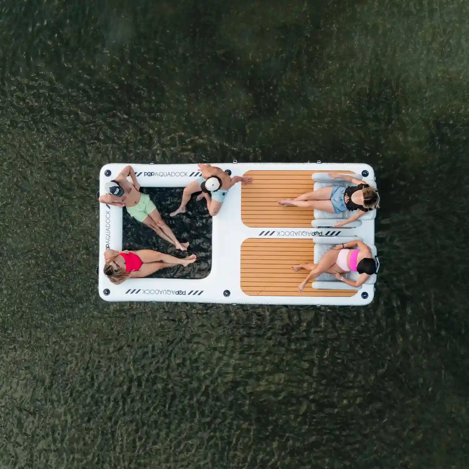 Aerial view of POP AquaDock inflatable dock with friends relaxing on the water.
