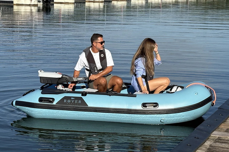 Couple seated in the 10 ft Rover Marine Battle Boat at the dock, ready to launch