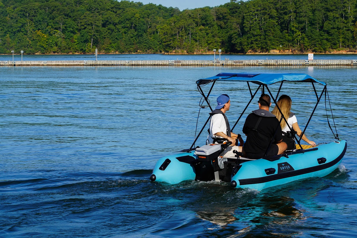12 ft Rover Marine Battle Cat with a Torqeedo electric outboard cruising past a dock