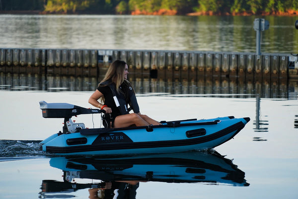 Woman driving the 8 ft Rover Marine Battle Cat with a Torqeedo electric outboard