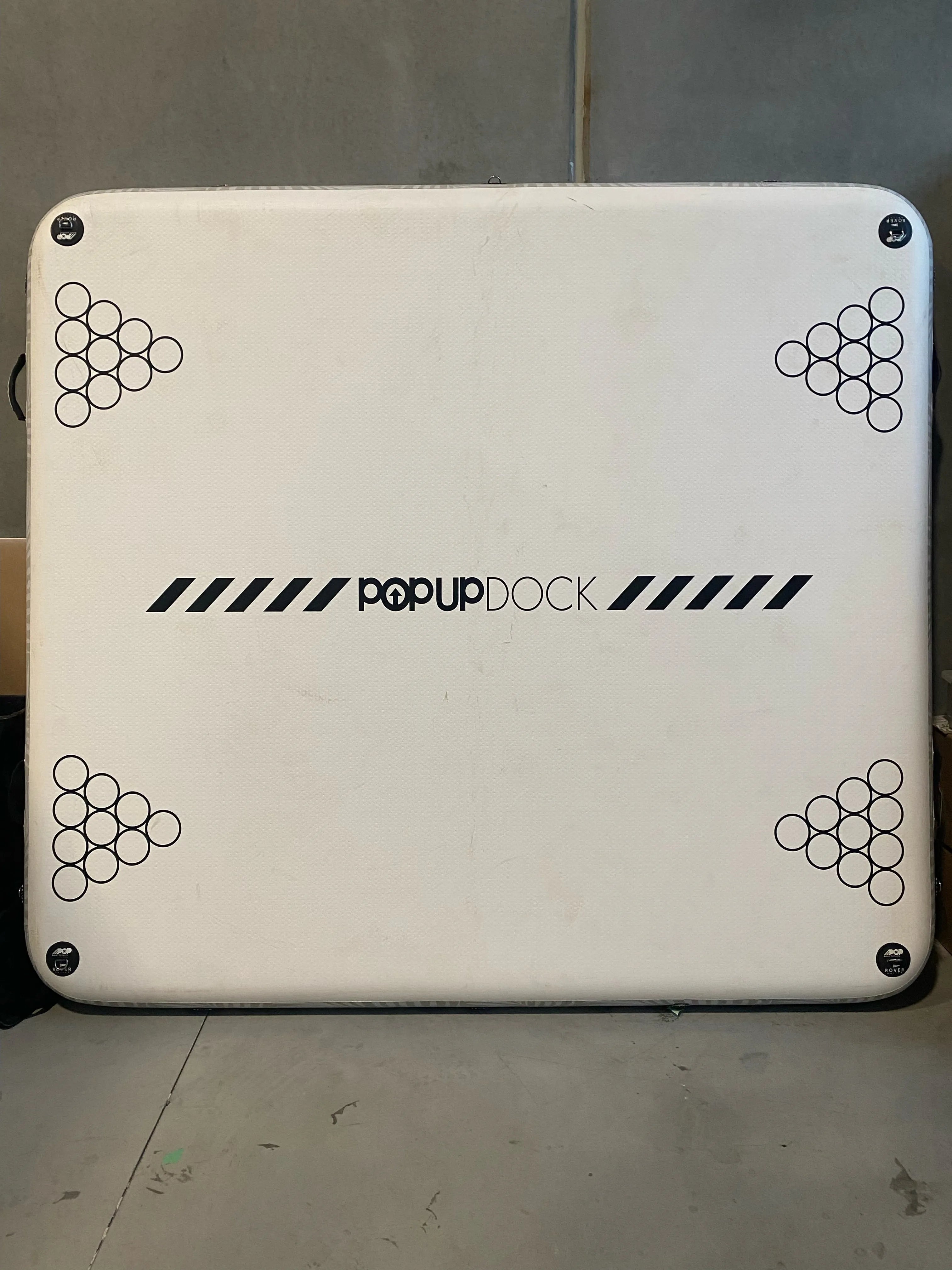 Bottom side of the used POP Up Dock from Canadian Board Co., displaying anchor point placement and mesh support areas.