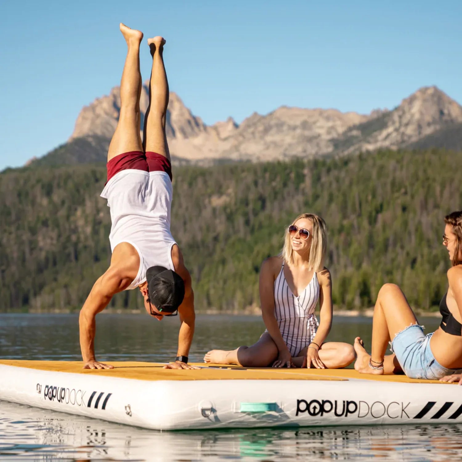 Group of friends enjoying lake adventures on a used POP Up Dock from the Green Program.