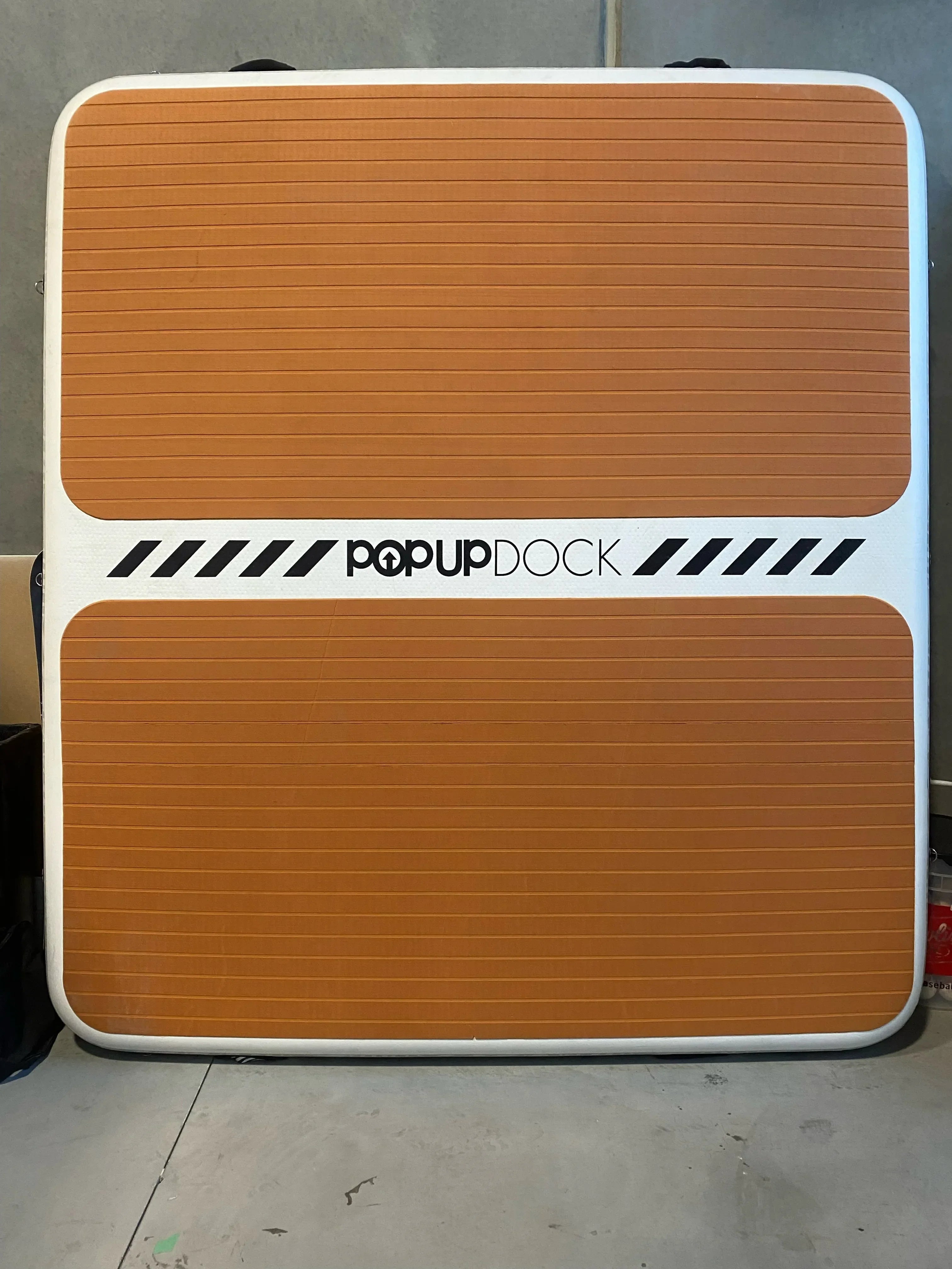Used POP Up Dock showing teak-style non-slip surface pad, photographed indoors for resale condition.