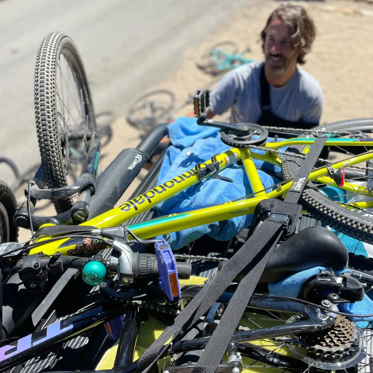 Premium Vamo tie down straps securing bikes and SUP boards to a roof rack.