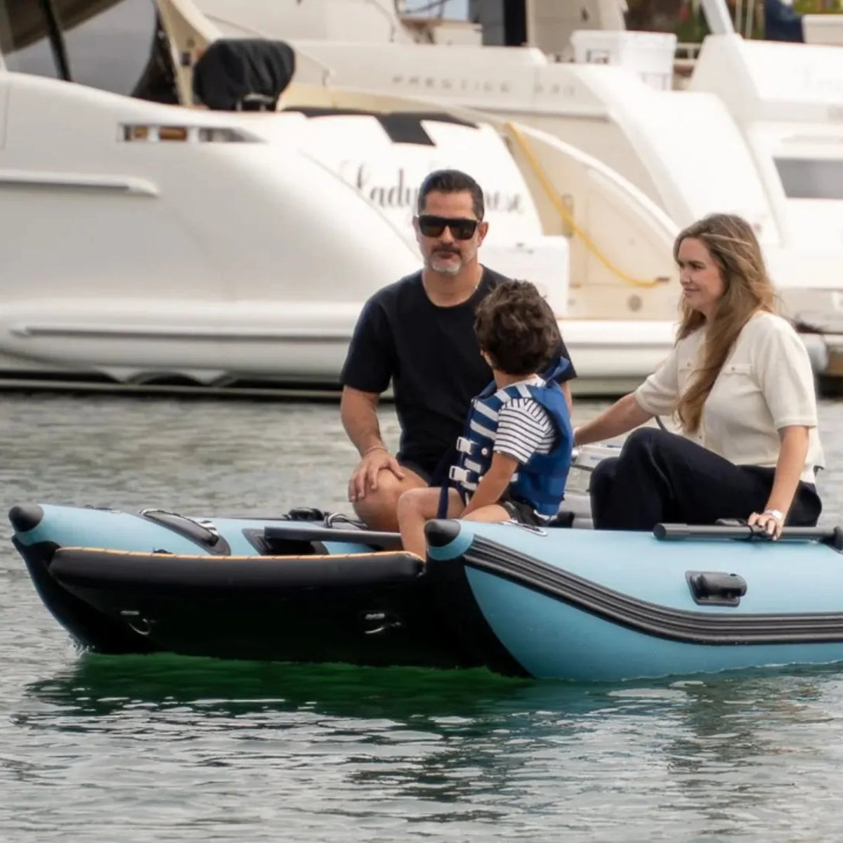 Family of three aboard a Rover Marine Battle Cat, the child wearing a lifejacket