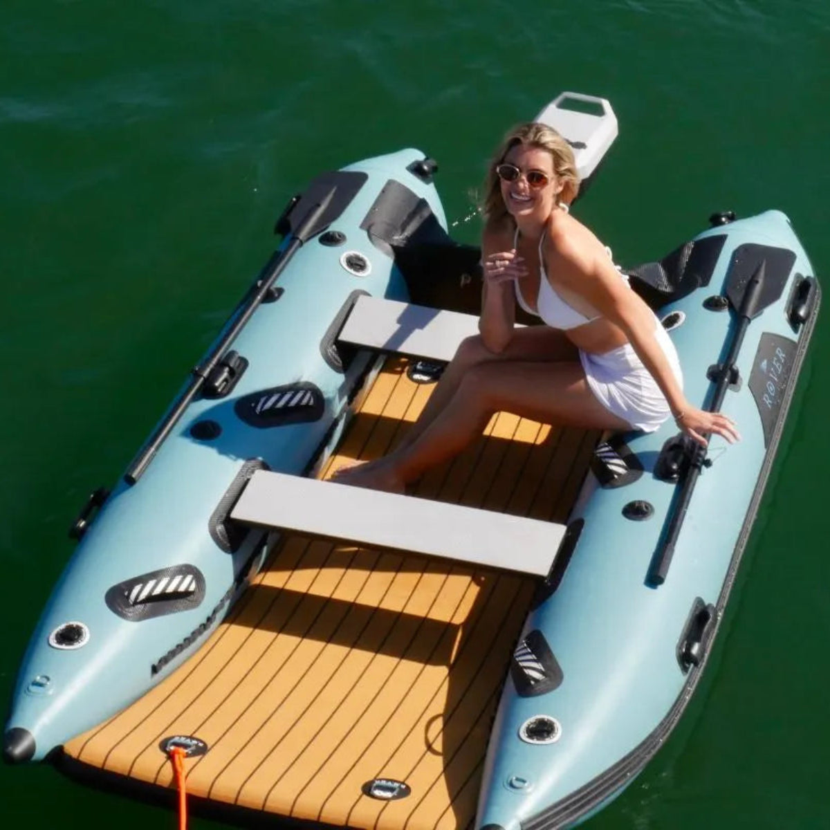 Woman sitting on a large inflatable boat on a body of water