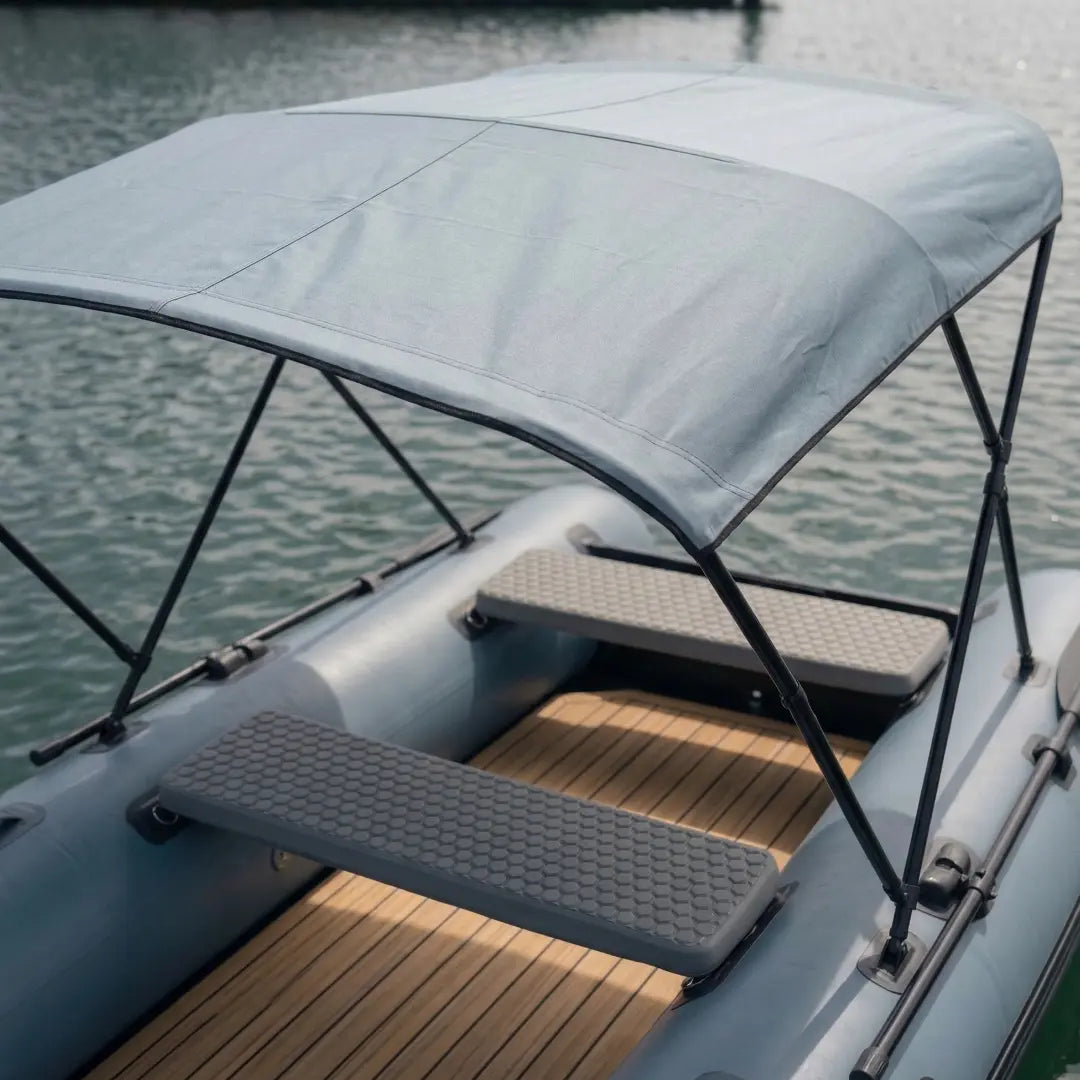 Inflatable boat with a canopy on a body of water