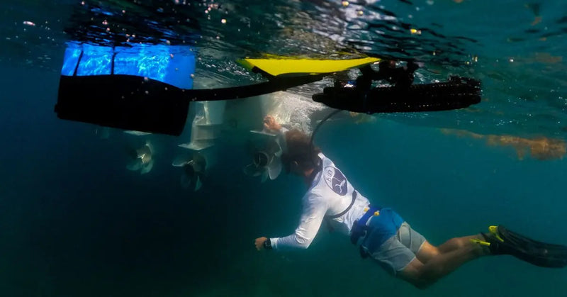 Person underwater checking the prop