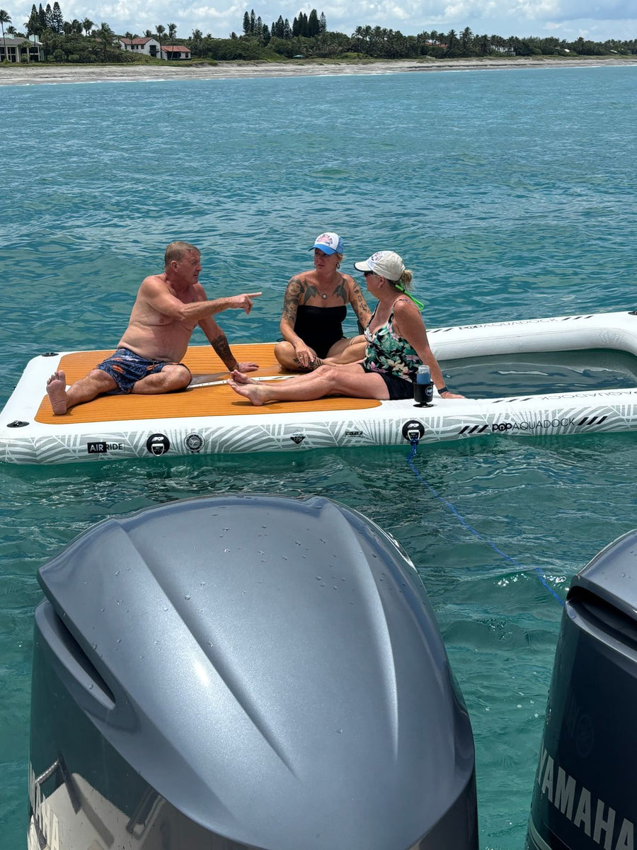 Friends on the AquaDock tied off behind a boat