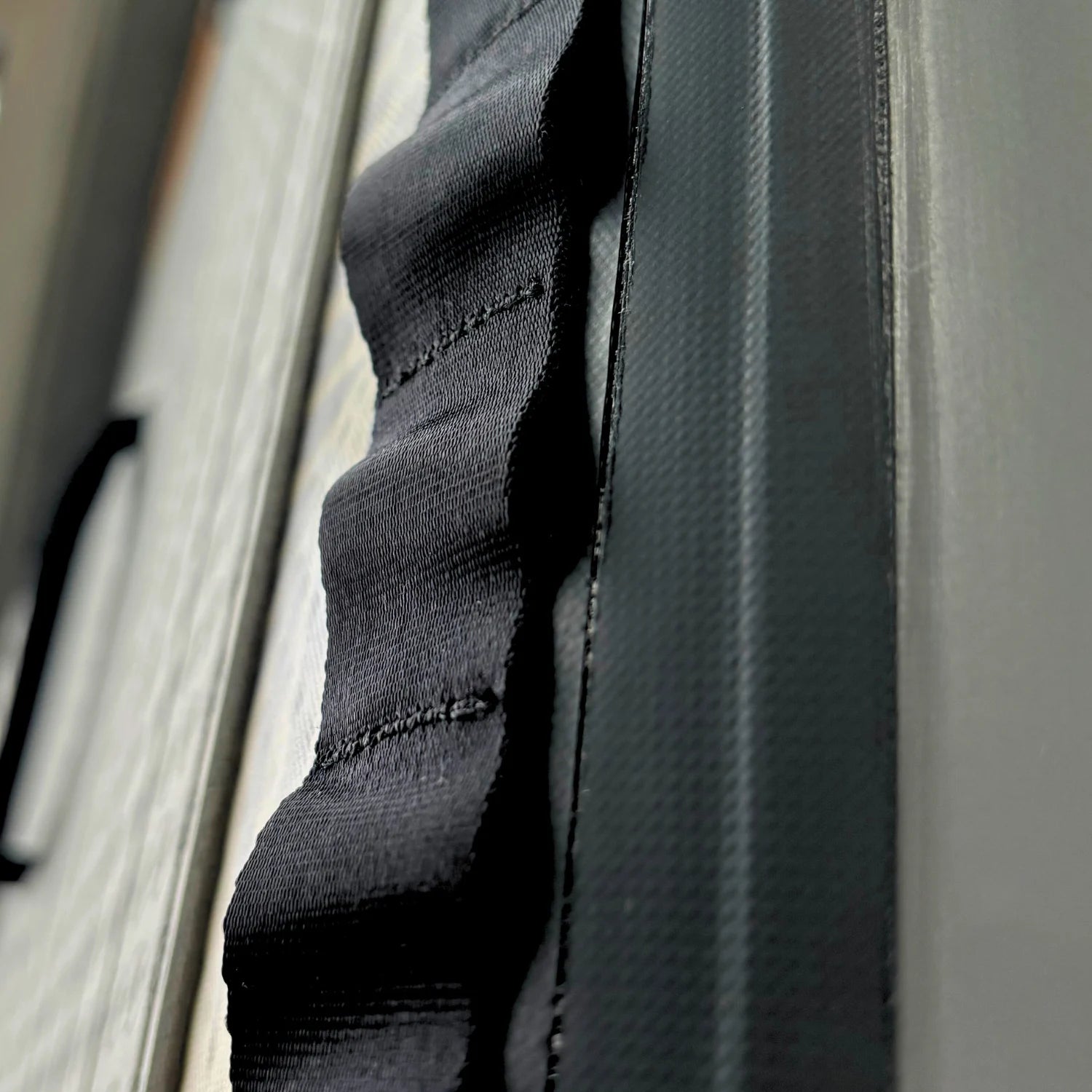 Close-up of El Capitan 11'6 Bomber paddleboard daisy chain attachment for gear storage and accessories.