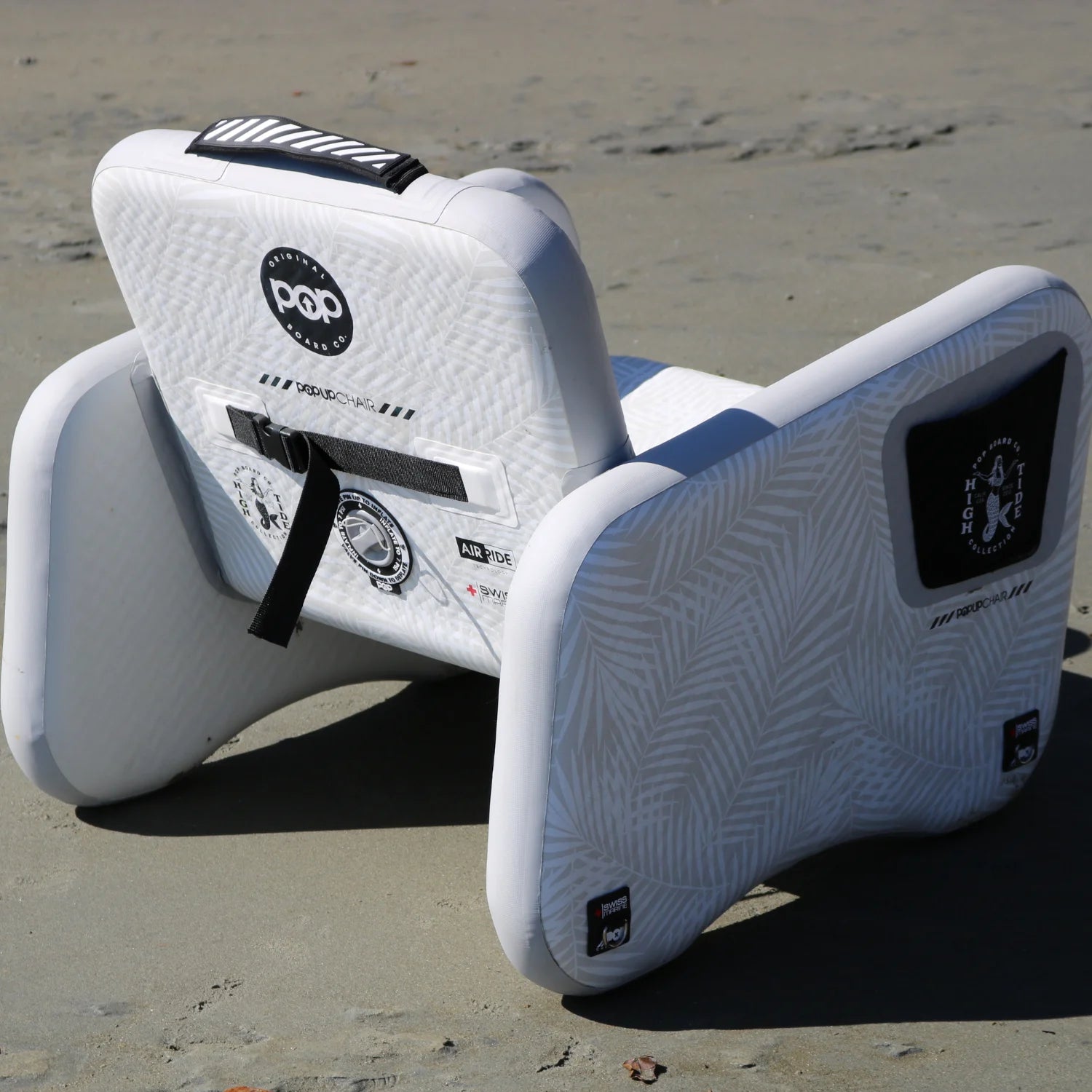 POP Up Chair inflatable chair on sandy beach, back view with reinforced details.