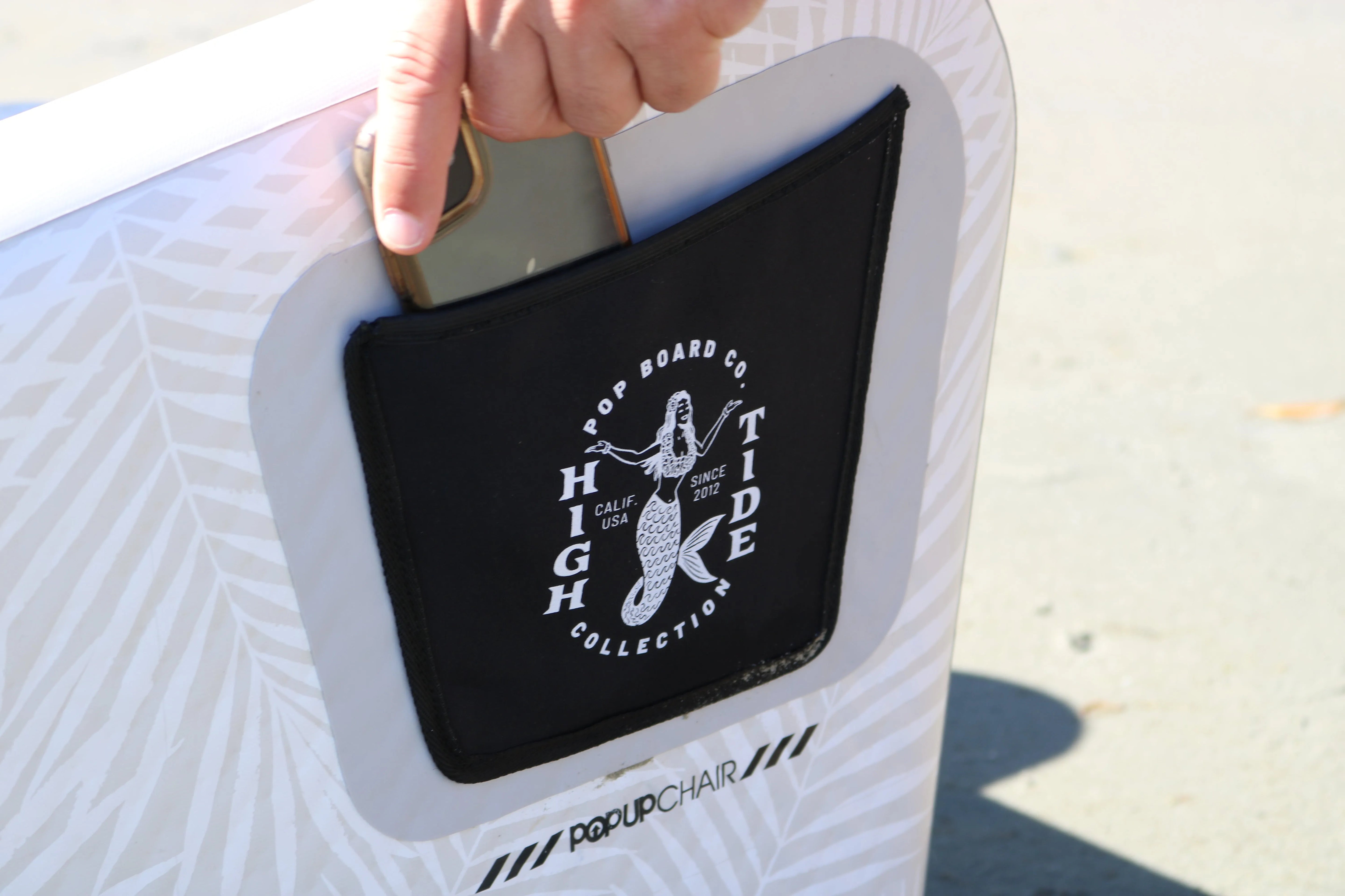 Close-up of POP Up Chair logo panel with built-in carry handle for easy lifting.