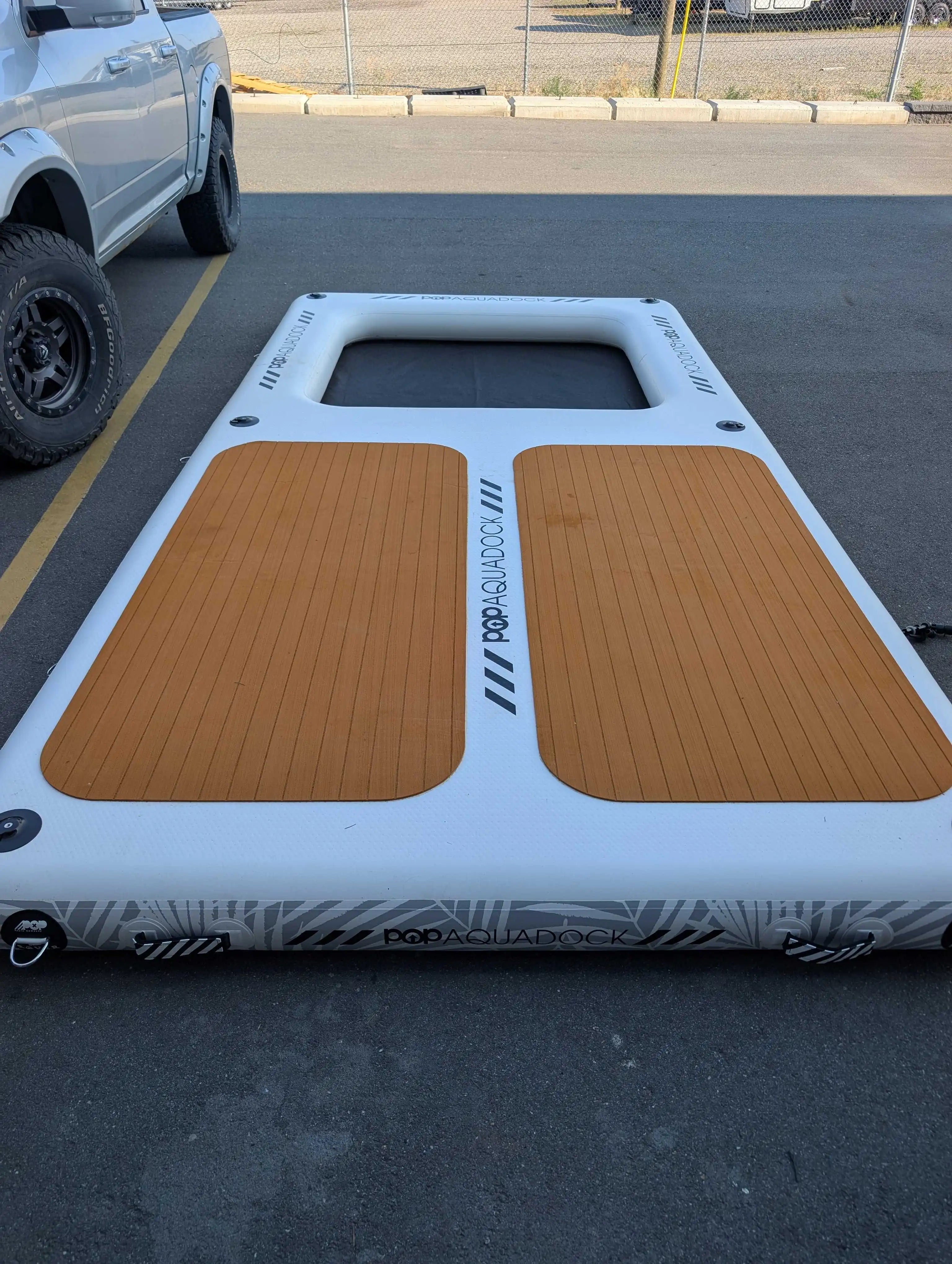 POP Up Aqua Dock 14x7 floating dock with traction pads and mesh hangout section, angled view.