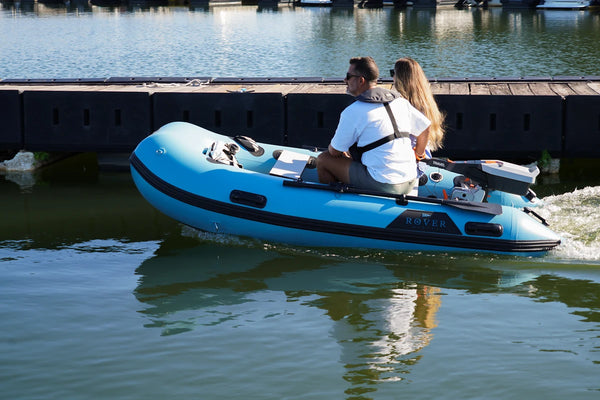 10 ft Rover Marine Battle Boat with a Torqeedo electric outboard cruising past a dock
