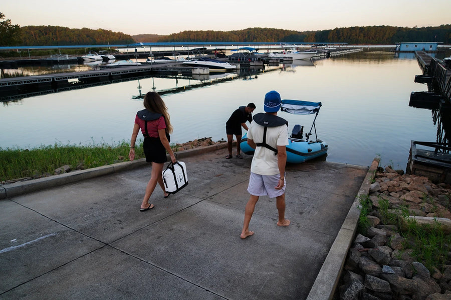 Friends launching the 12 ft Rover Marine Battle Boat at a boat ramp