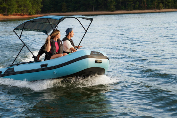 12 ft Rover Marine Battle Boat inflatable dinghy under power with three people aboard