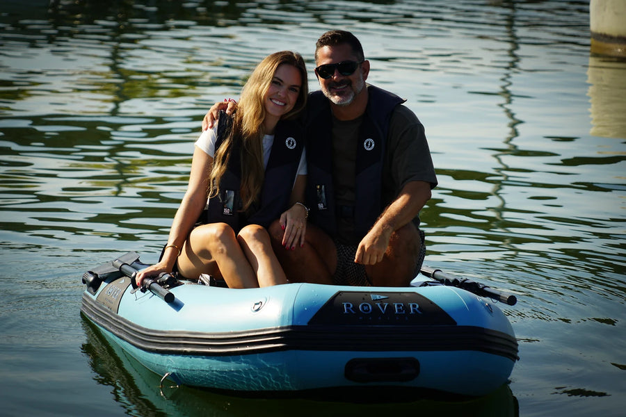 Couple sitting in the 8 ft Rover Marine Battle Boat inflatable dinghy on a lake