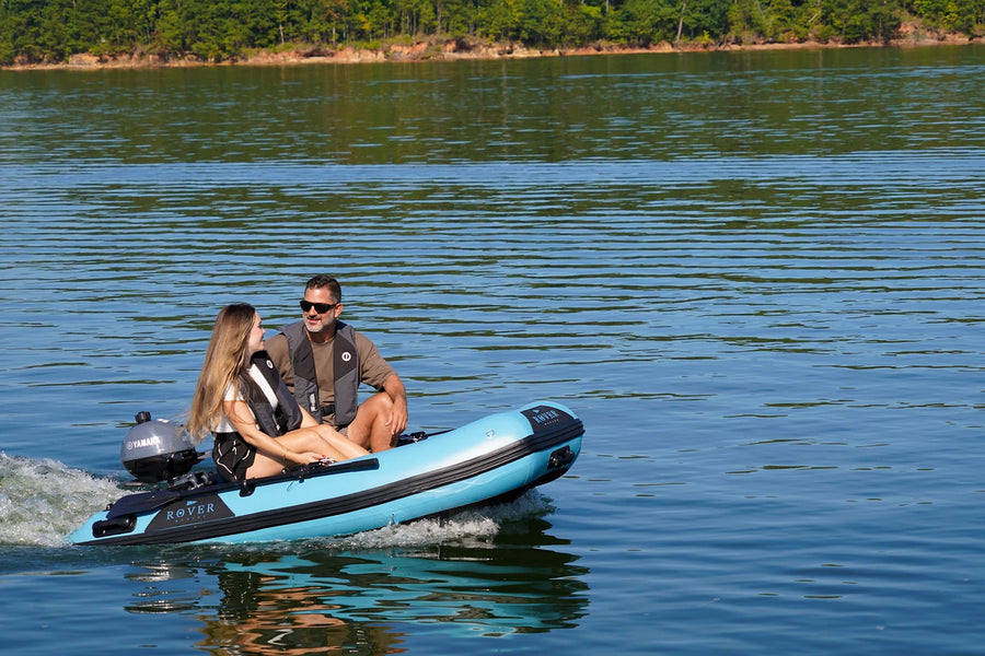 8 ft Rover Marine Battle Boat cruising across a calm lake with two people