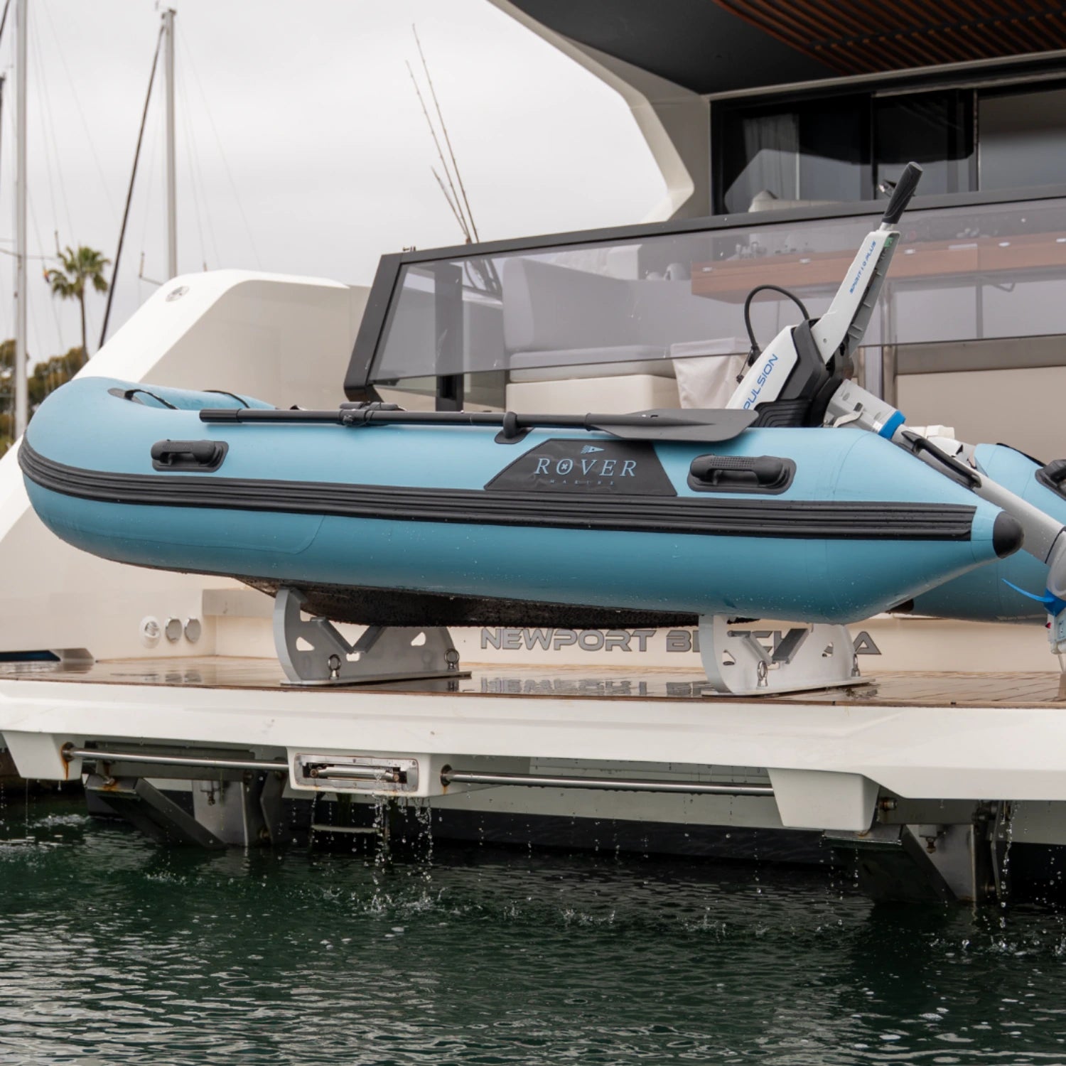 Rover Marine inflatable Battle Boat stored on a yacht platform with electric motor attached.