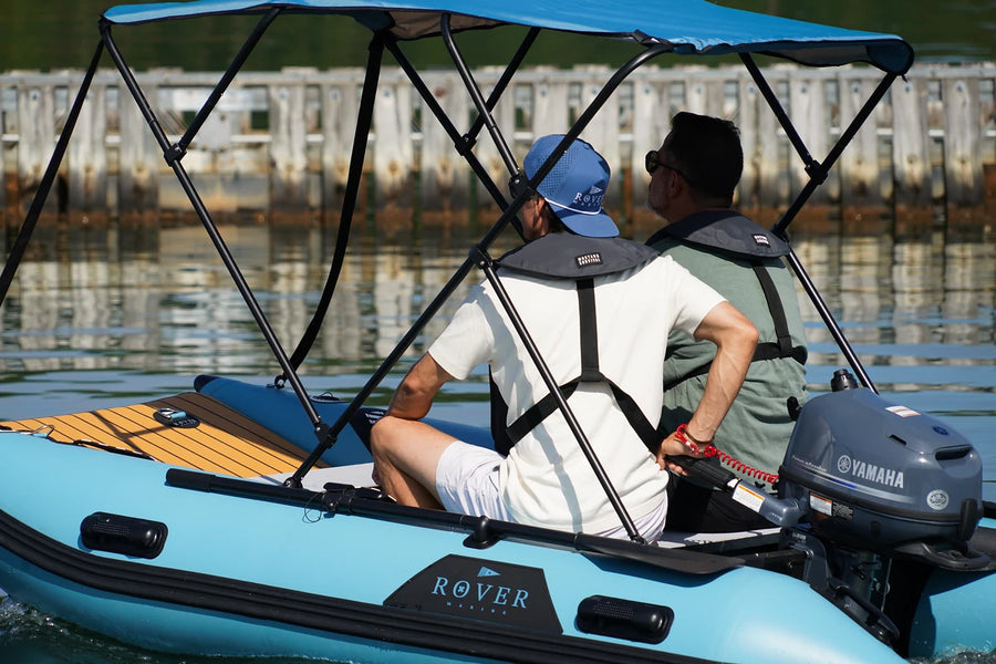Two people in the 10 ft Rover Marine Battle Cat under a Bimini top, sold separately
