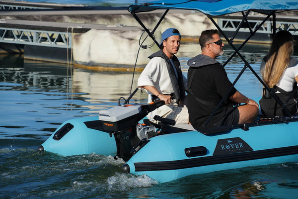 Three friends in the 12 ft Rover Marine Battle Cat under a solar Bimini top