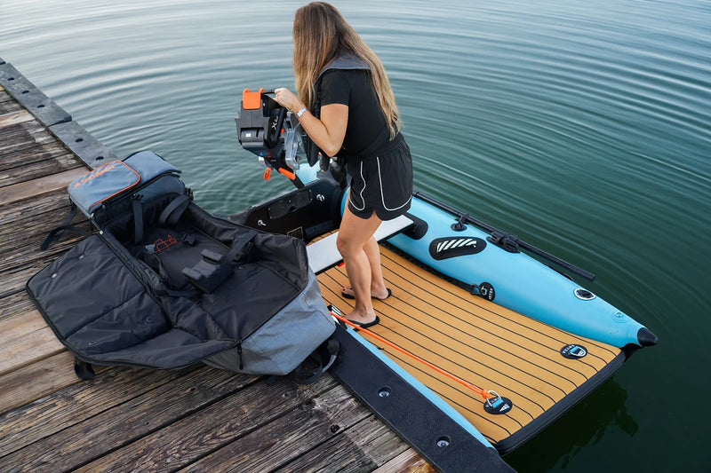 Unpacking gear on the dock beside the 8 ft Rover Marine Battle Cat