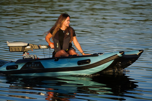 Woman driving the 8 ft Rover Marine Battle Cat inflatable catamaran on the lake