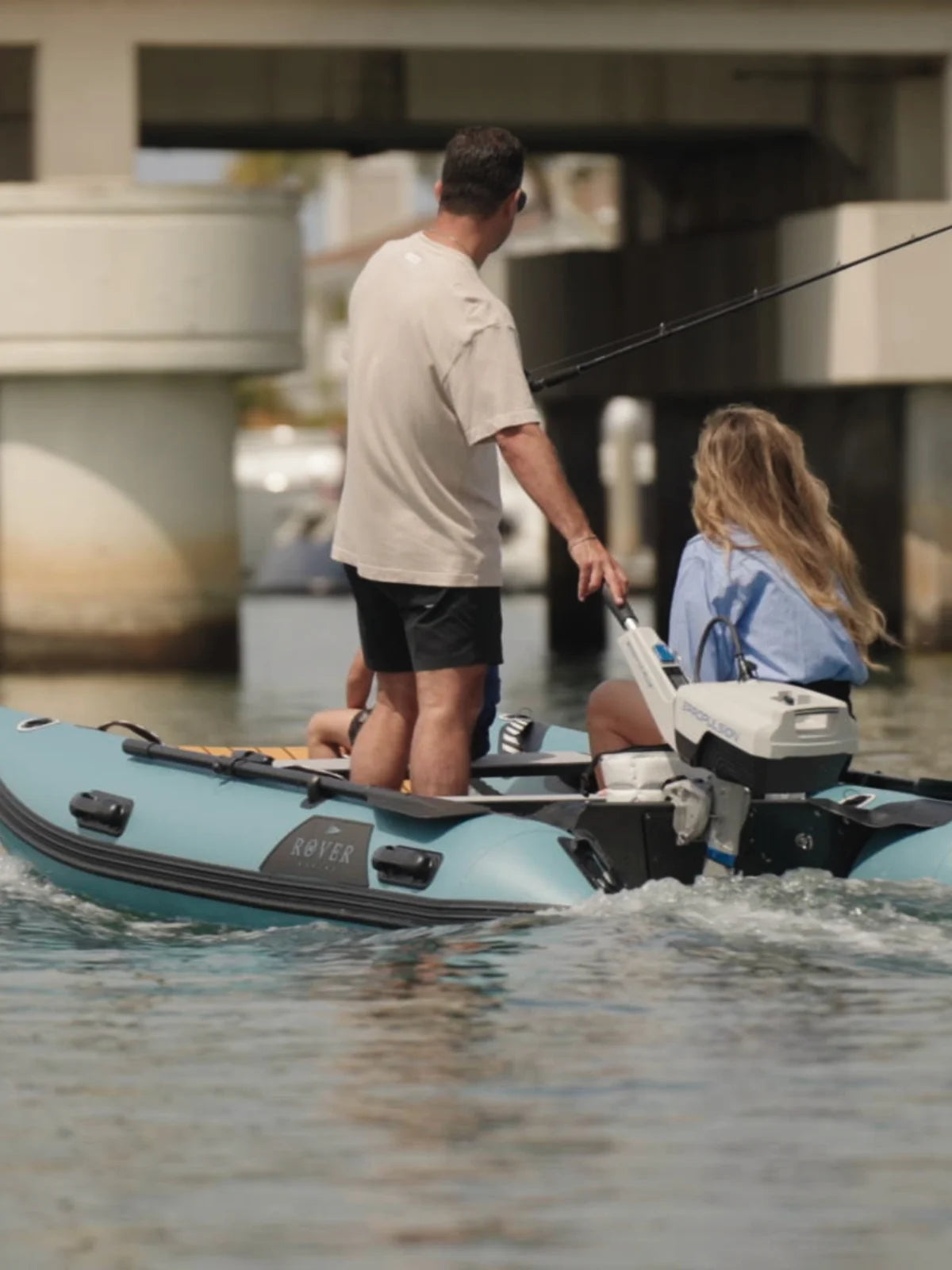 Couple navigating Rover Marine Battle Cat inflatable boat with electric outboard motor.