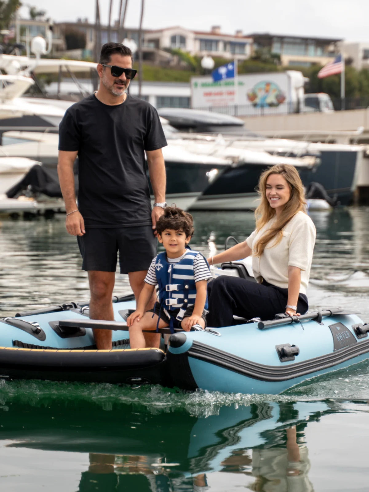 Family enjoying a ride on Rover Marine Battle Cat inflatable boat at the marina.
