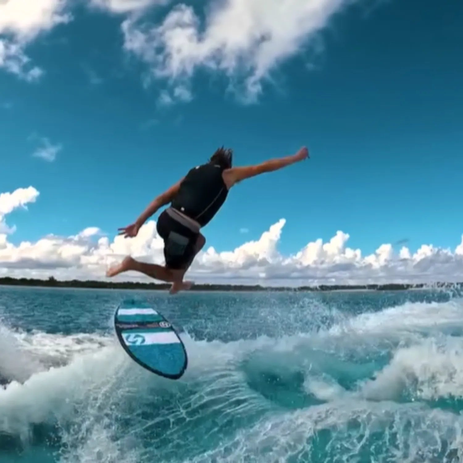 Rider mid-air trick on Vedder Stewy Cliff Jump Pro wakeskim board.