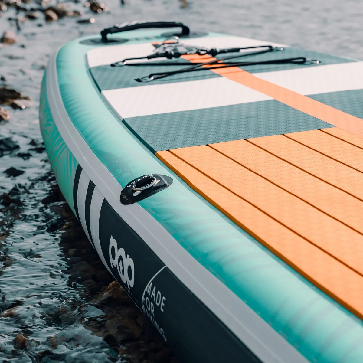 Front nose and teak deck detail of POP Yacht Hopper 11'0 inflatable paddleboard in blue and mint.